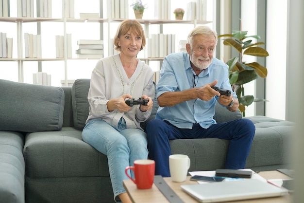 Happy Caucasian senior couple playing games at home