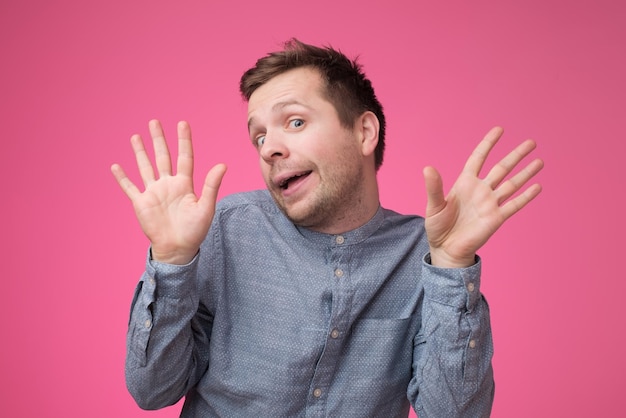 Happy caucasian smiling man showing ten fingers