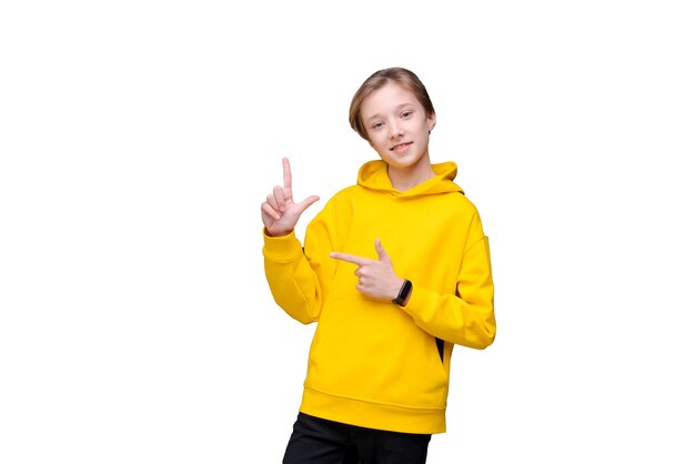 Happy cheerful smiling young caucasian man with blond hair dressed in a yellow sweatshirt on a white