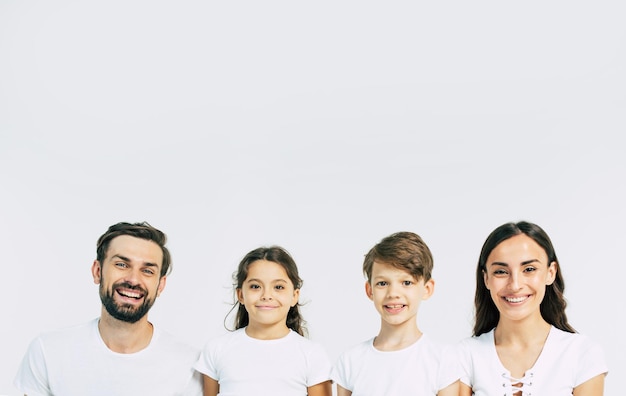 Photo happy and cheerful young beautiful family are smiling and posing while have a fun together over white background