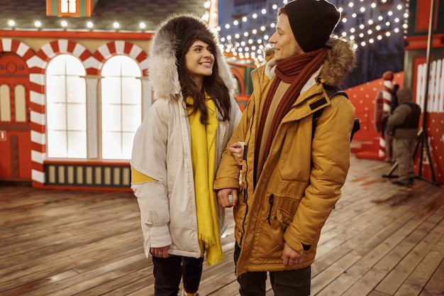 Happy cheerful and young caucasian couple are having fun while dating together outdoors in a city