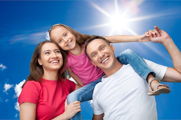 Happy cheerful young family on sky background, sunlight