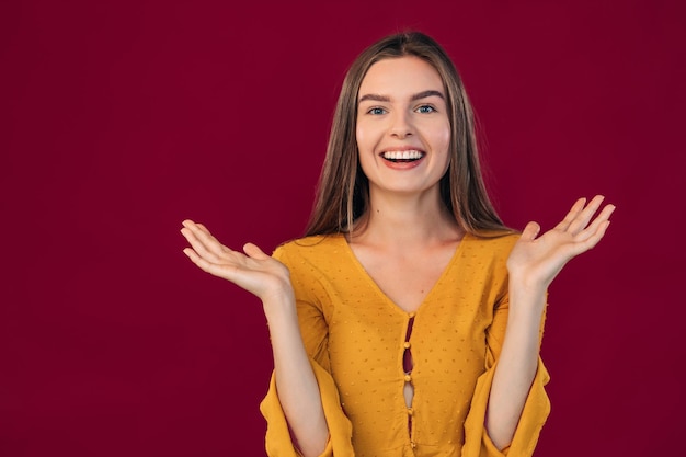 Happy cheerful young girl enjoying positive news or birthday\
present looking at camera with joyful and adorable smile