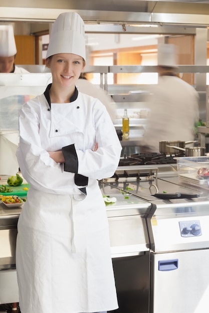 Happy chef leaning against stove