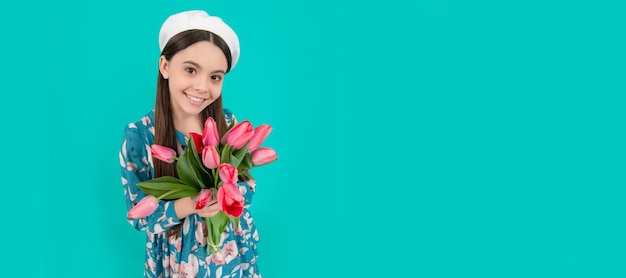 Happy child in beret with tulips mothers or womens day kid hold\
flowers for 8 of march banner of spring child girl with tulips\
flowers bouquet studio portrait with copy space