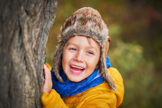 happy child boy playing outside in autumn