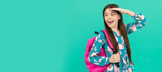 Happy child carry backpack going to school looking far away Banner of school girl student Schoolgirl pupil portrait with copy space