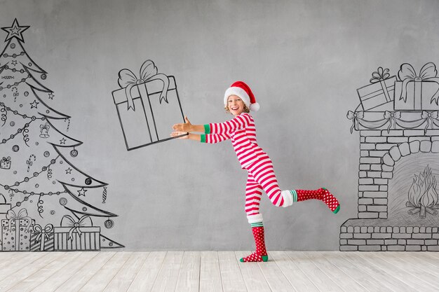 Happy child in Christmas time. Funny kid playing at home