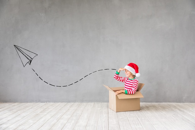 Happy child in Christmas time. Funny kid playing at home