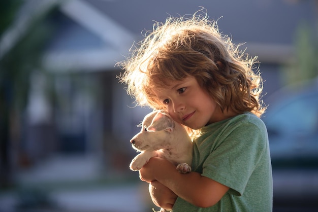 Happy child and dog hugs her with tenderness smiling
