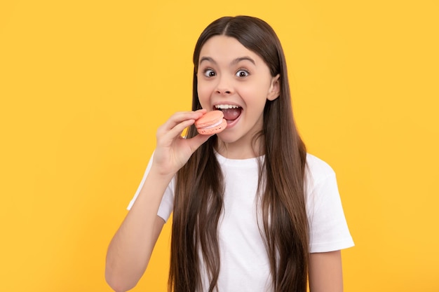 Happy child eat dessert bakery kid hold french macaron macaroon cookie confectionery