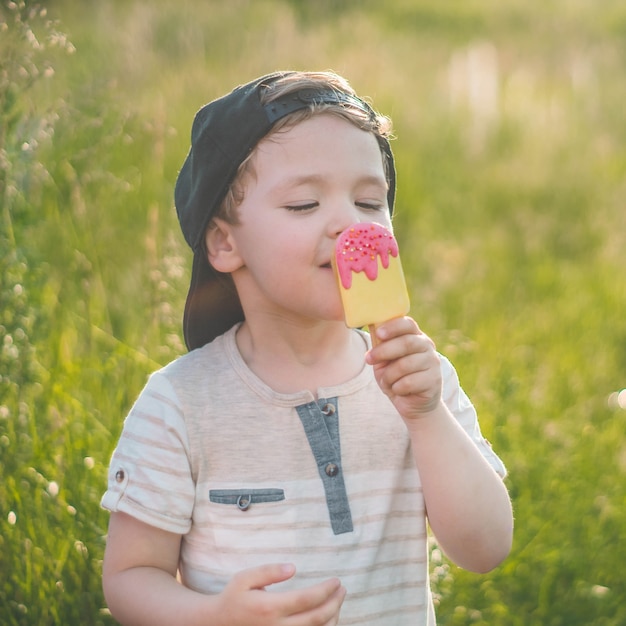 Happy child eating cookies in the form of ice cream