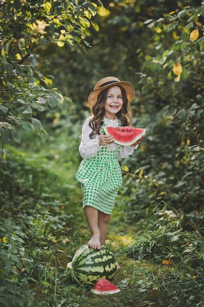 Photo a happy child eats a juicy slice of watermelon 1896