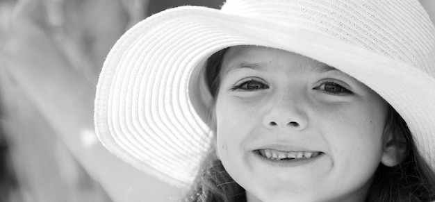 Happy child face closeup child teen girl has summer joy happy day cute playful cheerful kid with