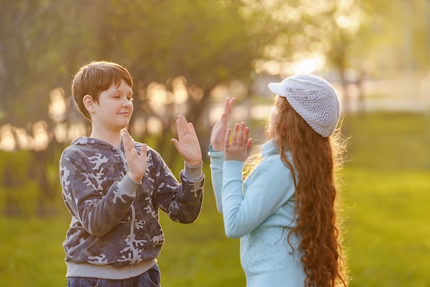 Happy child friend enjoying clapping hands.