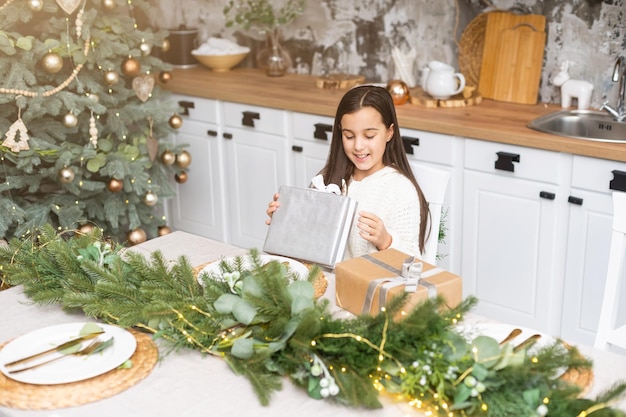 クリスマスに奇跡を待っている幸せな子供の女の子。