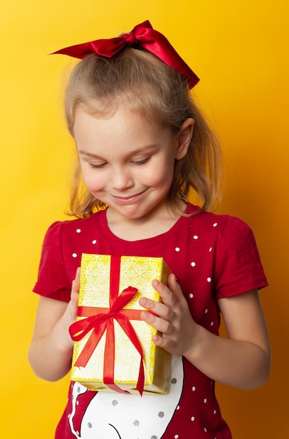 Happy child girl with gift box