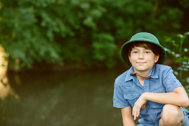 Happy child go hiking with backpack in summer nature