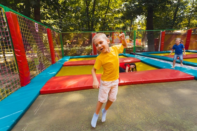 the happy child have a nice day in the trampoline park