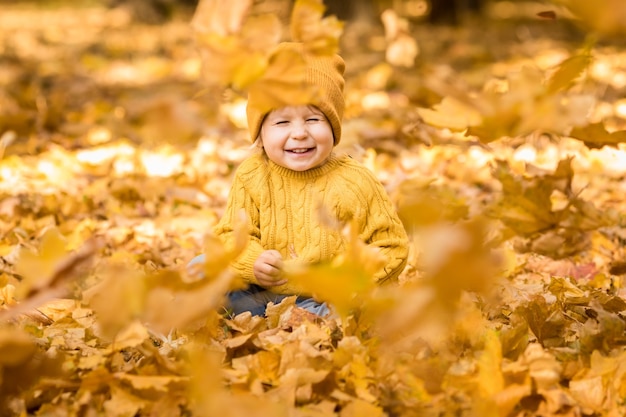 Happy child having fun outdoor in autumn park