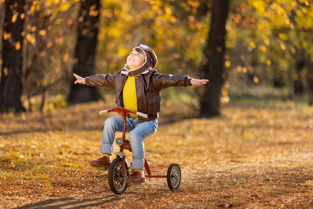 Happy child having fun outdoor in autumn park