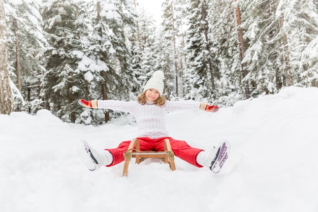 Happy child having fun outdoor. Kid playing in winter time. Active healthy lifestyle concept