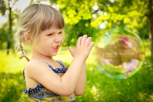 Happy child having fun playing in the nature park