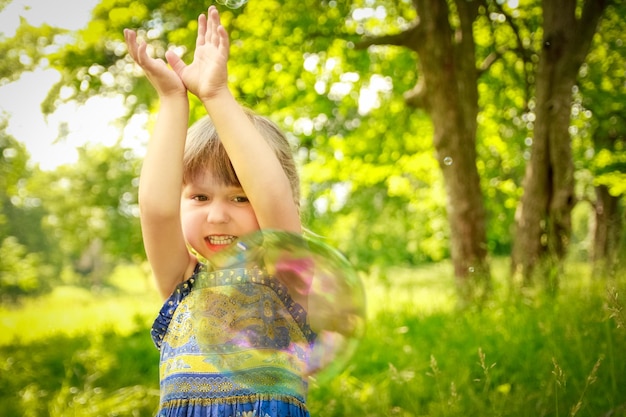 Happy child having fun playing in the nature park