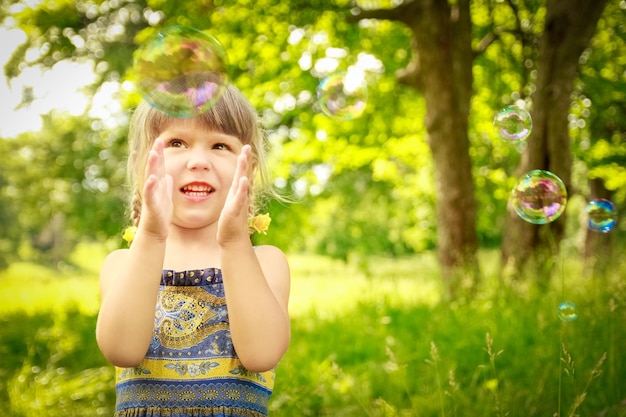 Happy child having fun playing in the nature park