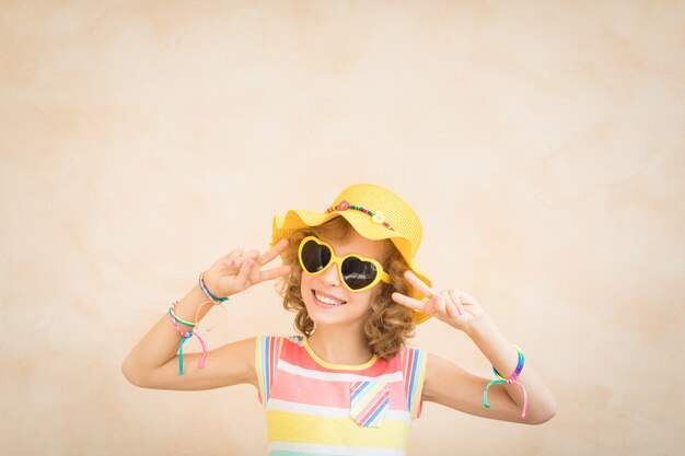 Happy child having fun on summer holidays Portrait of teenager girl indoor