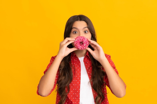 Happy child having fun with sweet glazed donut food