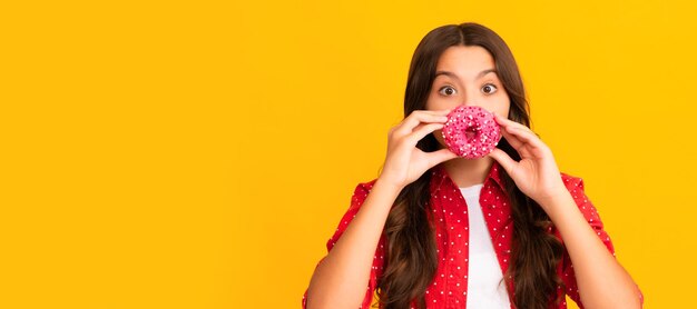 Happy child having fun with sweet glazed donut food