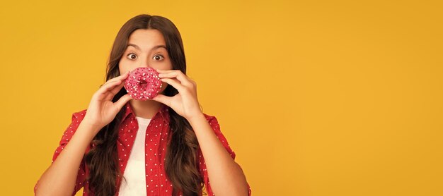 Happy child having fun with sweet glazed donut food