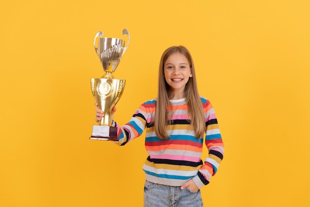 happy child hold golden cup. achievement award. celebrating school success. trophy and prestige. got prize. kid award prize happy teen girl celebrate victory. school olympiad winner. genius.