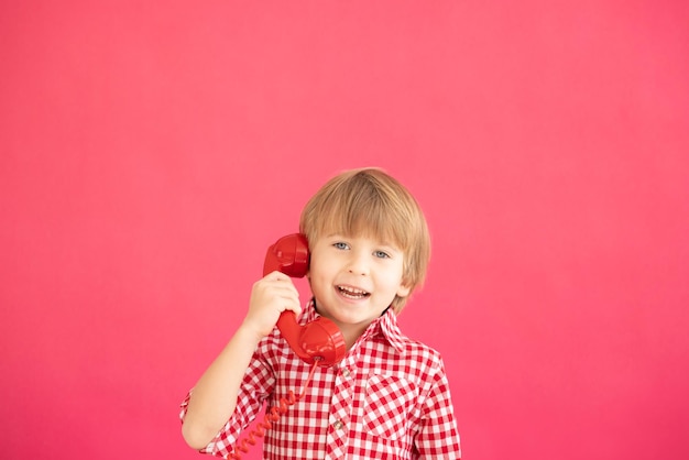 Happy child holding phone in hand