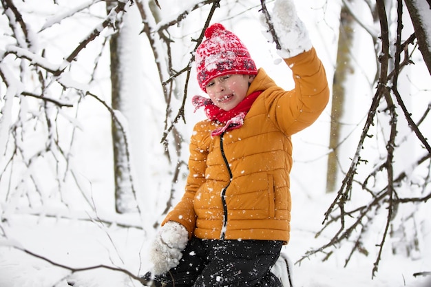 Happy child is having fun and playing in winter