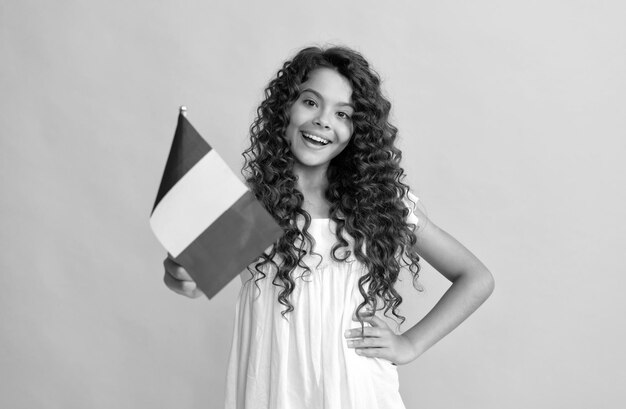 Happy child long curly hair hold french flag france