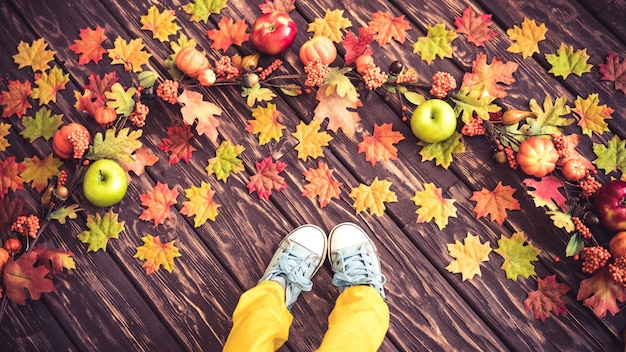 Happy child lying on autumn leaves