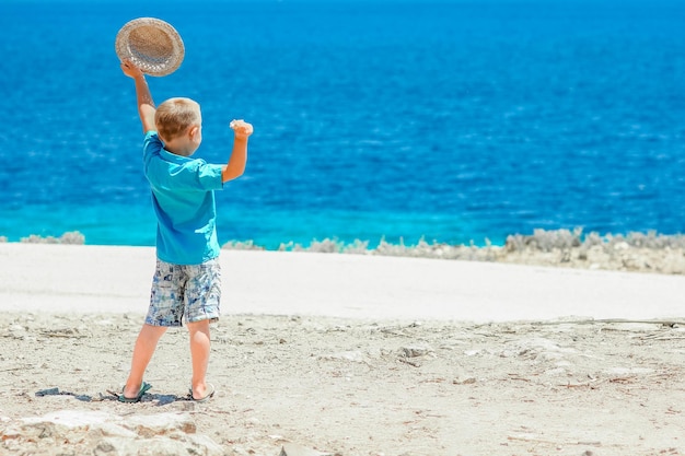 A happy child near the sea in nature on a weekend trip