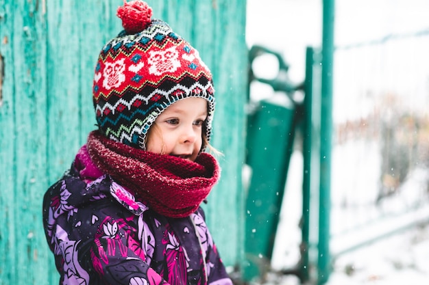 Foto bambino felice all'aperto in inverno sullo sfondo della natura ritratto di bambino che guarda da un lato