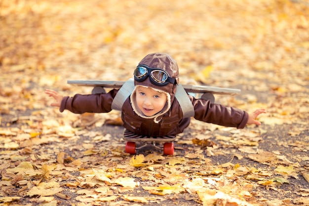 Happy child playing in autumn