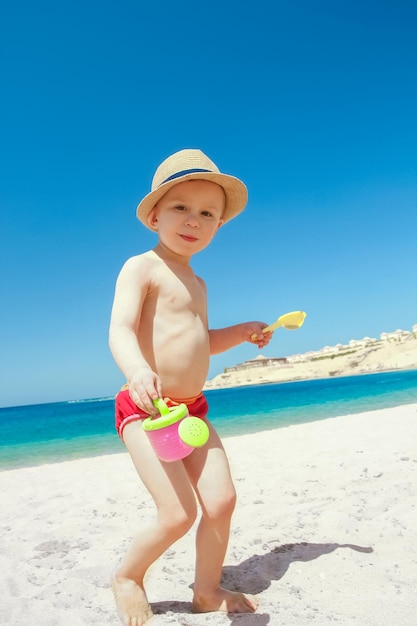 Happy child playing by the sea on nature background