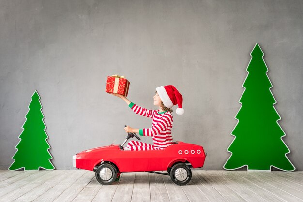 Happy child playing at home. Funny kid on Christmas eve.