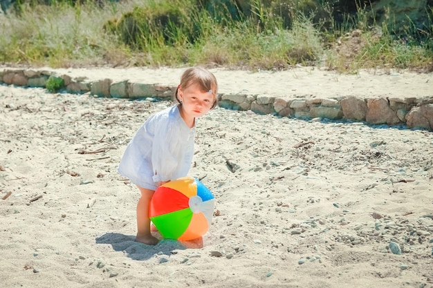 Happy child playing on the shore of the Greek sea