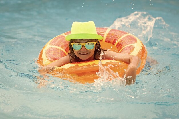 Happy child playing in swimming pool Summer vacation concept Summer kids portrait in sea water on beach