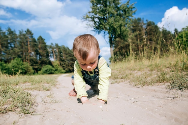 Happy child playing with sand outdoors