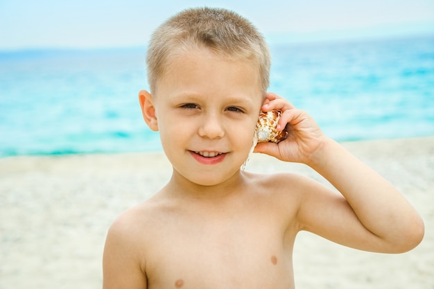 Happy child portait playing by the sea