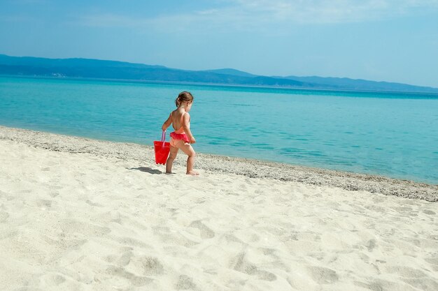 Happy child at sea in greece plays in nature