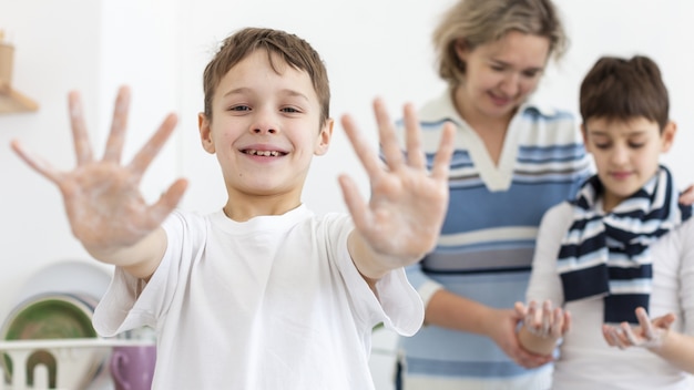 Photo happy child showing hands while washing