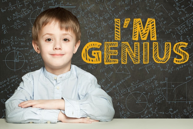 Happy child student on blackboard background with science and maths formula